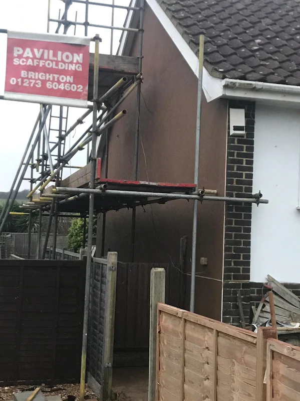 The render coat beside the brick pier