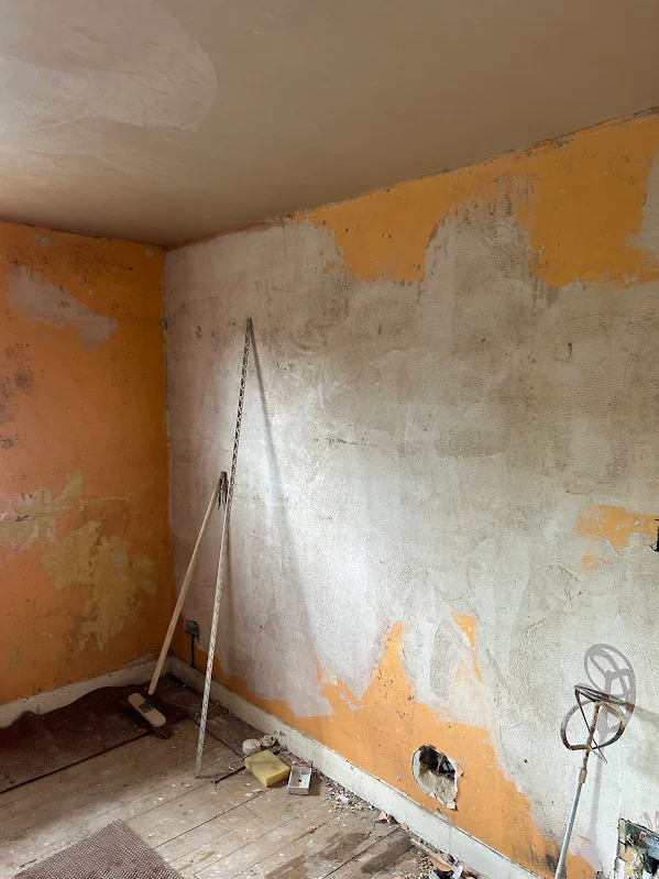 Orange paint scraped back to the wall