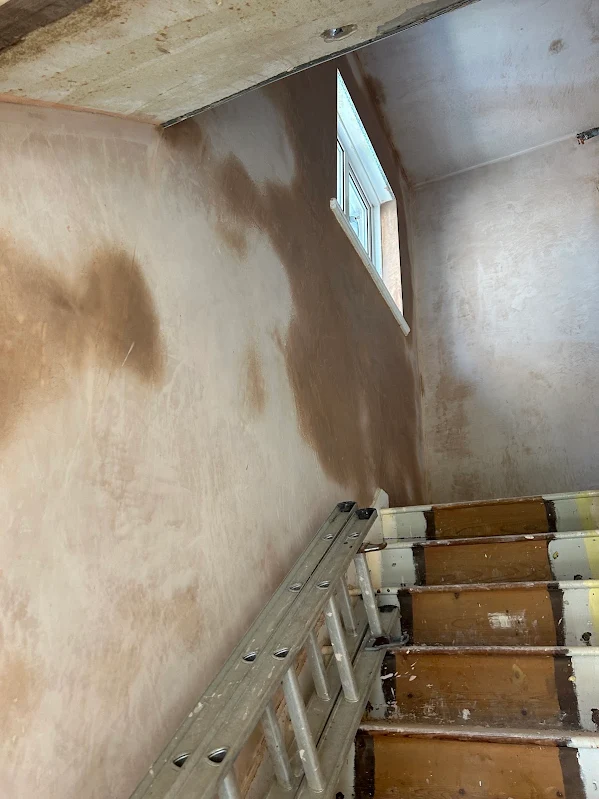 Looking up the stairs at the new plaster
