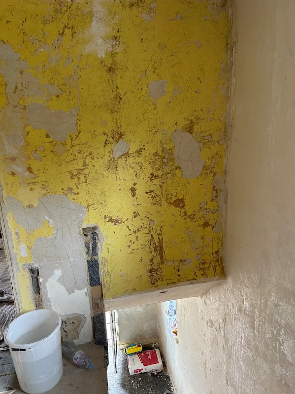 Yellow paint on the wall above the stairs